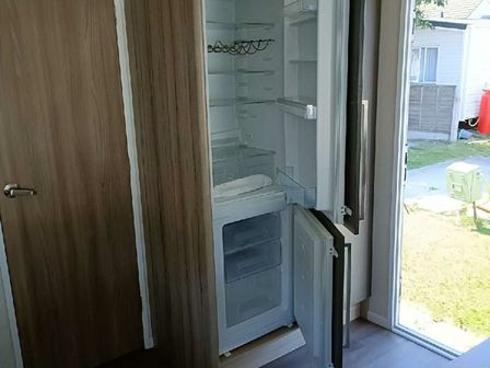 a refrigerator with its door open in a room with a view of the outdoors at Lyons Winkups and Primrose - Holiday Accommodation 22330 Towyn