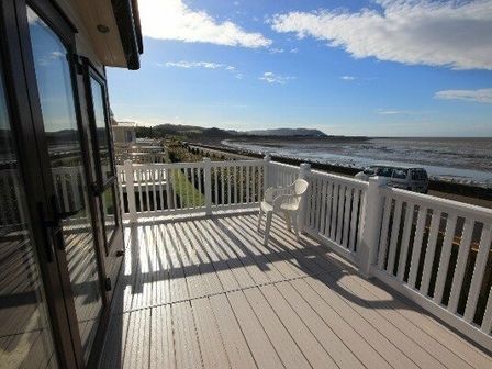 a view of a balcony overlooking a beach at Hoburne Blue Anchor - Holiday Accommodation 2382 Near Minehead