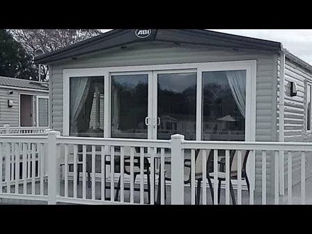 a holiday home exterior with large windows and a deck at Seashore Holiday Park - Holiday Accommodation 5283 in Great Yarmouth