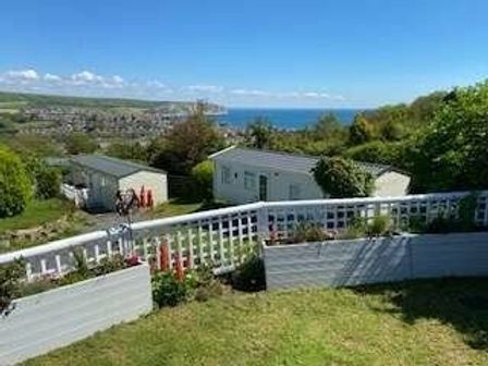 a view of a coastal landscape with caravans and a garden at Swanage Bay View - Holiday Accommodation 5921 in Swanage