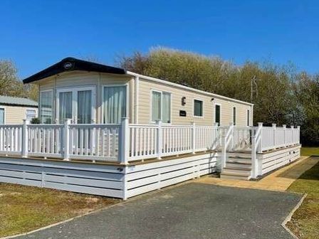 a holiday home with a deck and steps at Greenacres Holiday Park - Holiday Accommodation 6757 in Porthmadog