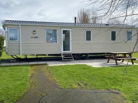 a mobile home exterior with a picnic table in front at Butlins Minehead - Holiday Accommodation 6829 Minehead