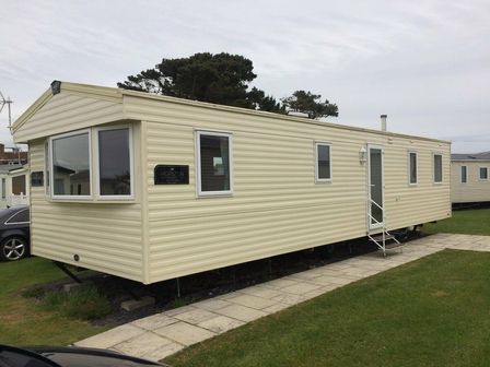 a static caravan located on a grassy area at Littlesea Holiday Park - Holiday Accommodation 8278 Weymouth