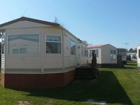 two static caravans situated on greenery at Trimingham House Caravan Park - Holiday Accommodation 8974 in Trimingham
