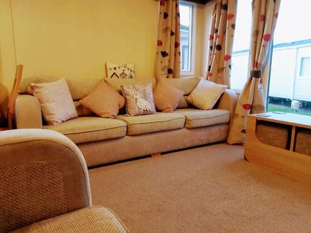 a living room with a sofa and curtains at Cala Gran Holiday Park - Holiday Accommodation 9468 in Fleetwood