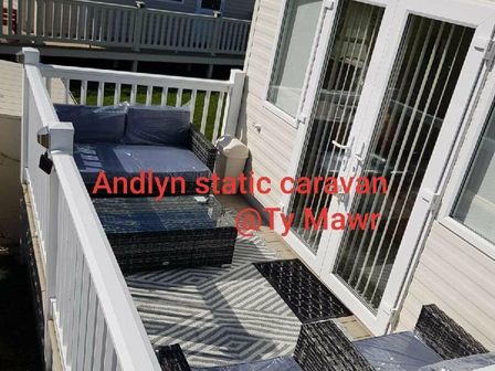 a balcony with outdoor furniture at Andlyn static caravan at Ty Mawr Holiday Park - Holiday Accommodation 9766 Towyn