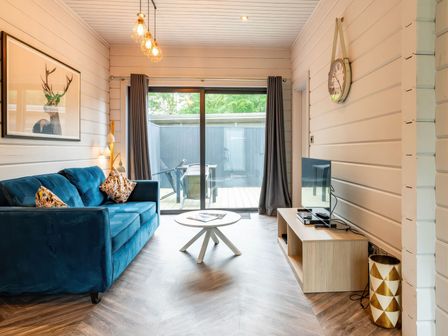 A living room with a blue sofa and a coffee table at Askrigg (Pet) Aysgarth