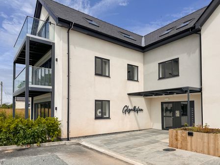 A building exterior with entrance and signage at Glynllifon 6, Marianglas