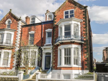 A building with multiple windows and a balcony at Esplanade Gardens, Apartment 1 Scarborough