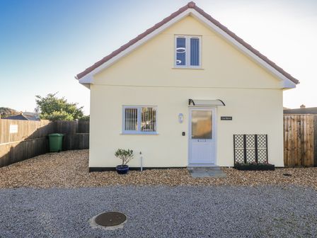 A house with a front door and gravel area at Cosy Retreat in Pool