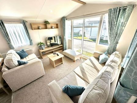 A living room with a TV and a coffee table at The Old Barn in Manchester