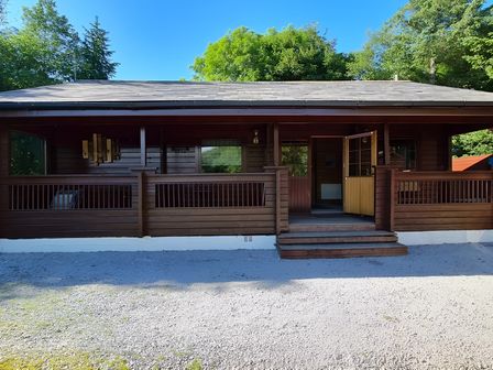 A lodge with steps and railings at Gisburn Forest Lodge