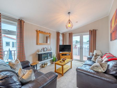 A living room with a television and sofa at 311 Bridlington