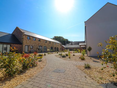 An outdoor area with buildings and a pathway at The Galloway in Morpeth