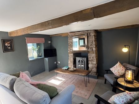 A living room with a sofa and television at Ty Llaeth in Carmarthen