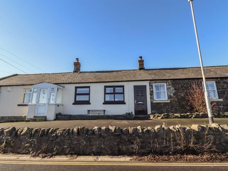 A house with multiple windows and a door at 2 Sunny Brae Embleton