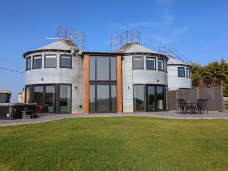 An outdoor view of a modern building with round structures at The Corn Silo in Ipswich
