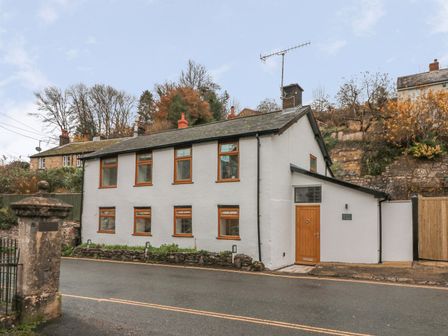 A house with windows and a door at The Old Workshop in