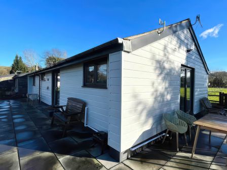 An outdoor patio with seating at River View Cottage in Llanrwst