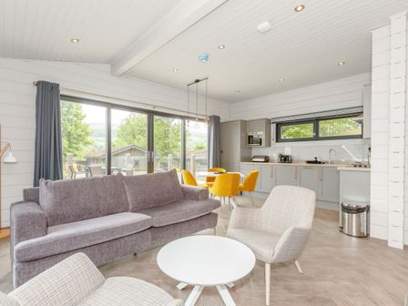 A living room with a sofa and dining area at Leyburn