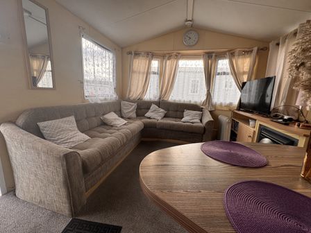 A living room with a sofa and television at 29 Laburnham Court in Fleetwood