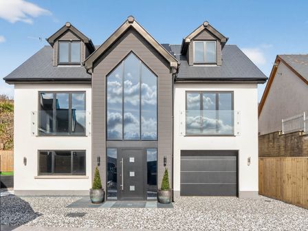 A house with large windows and a garage at Heddfan in Carmarthen