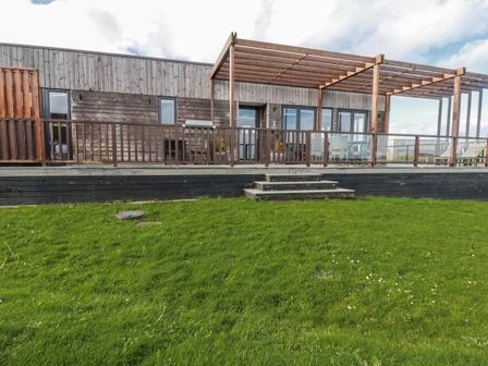 An outdoor area with wooden decking and a pergola at Adelaide in Redruth
