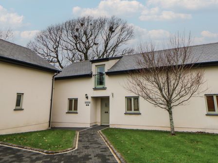 A building with a front door and windows at Rose Apartment in Oldwalls near Reynoldston