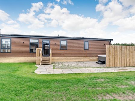 A cabin with steps and a hot tub at Beech Waterside Spa (Pet) Carlton Miniott near Thirsk