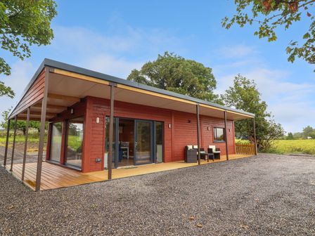 A cottage with a deck and outdoor furniture at Killinure Cottage, Glasson, County Westmeath
