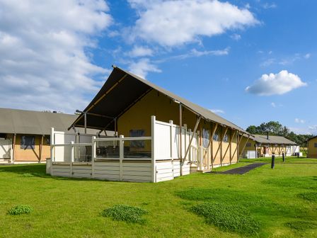 A group of tents with a deck in an outdoor setting at Kruger in Penrith