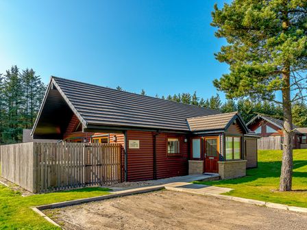 A house with a path and trees at Raeburn Premier Spa in Dundee