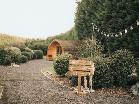 An outdoor area with a signpost and a pod at Garden Pod VIP in Waltham