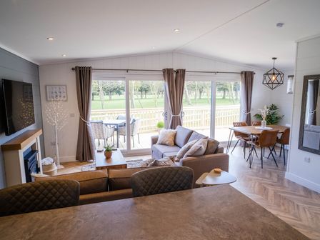 A living room with a sofa and dining area at Imperial View in Waltham