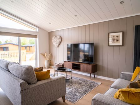 A living room with a television and coffee table at The Luxury Escape in Waltham
