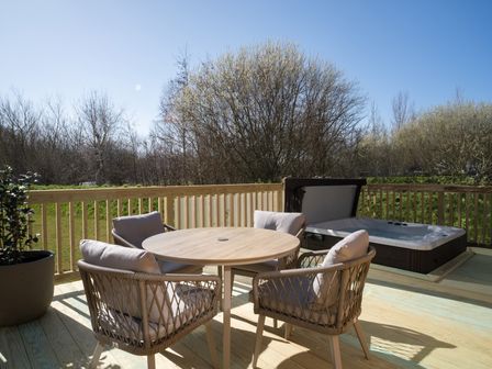 An outdoor space with chairs and a table near a hot tub at Marrakech Waltham