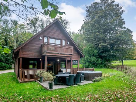 A house with a deck and hot tub at Cornwall Lodge Spa in Praze-An-Beeble