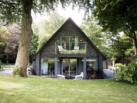 A house with a balcony and deck at St Austell Lodge Spa in Praze-An-Beeble