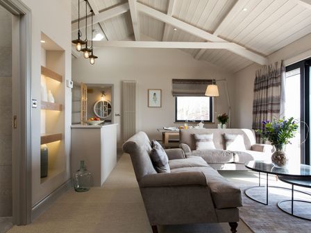 A living room with a sofa and coffee table at Dylan Spa in Laugharne
