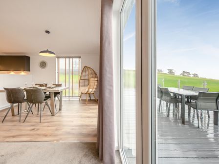 A dining room with a table and chairs at Sonnet 2 Spa in Laugharne
