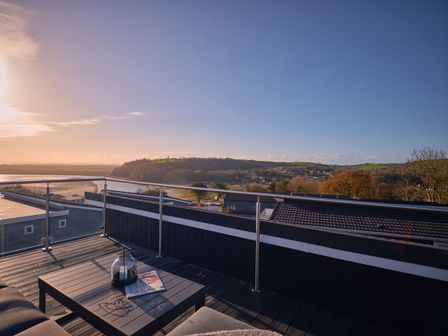 A terrace with a table and a view at Epic Spa (Roof Terrace) in Laugharne