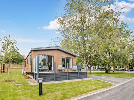 A cabin with decking and furniture in an outdoor area at Saron 2.0 Pet in Llandyrnog