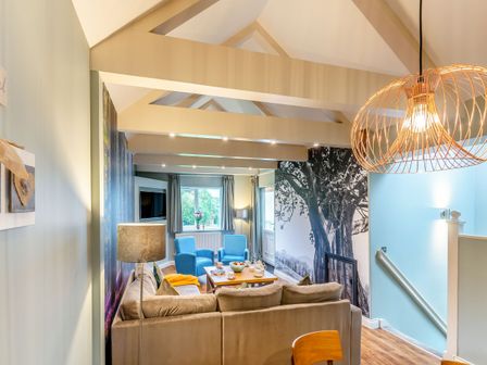 A living room with a sofa and coffee table at The Whitbarrow Den in Penrith