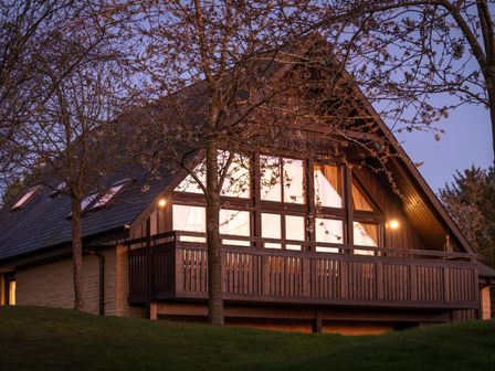 A house with a balcony and trees at The Hexham (Pet) in Slaley