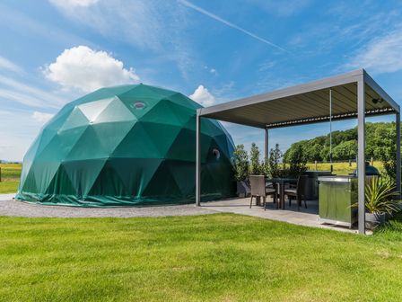 A geodesic dome with a patio and seating area at The Dome (Pet) in Great Ayton
