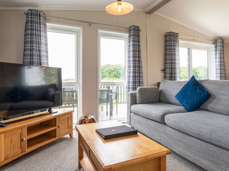 A living room with a sofa and television at Rosedale in Great Ayton