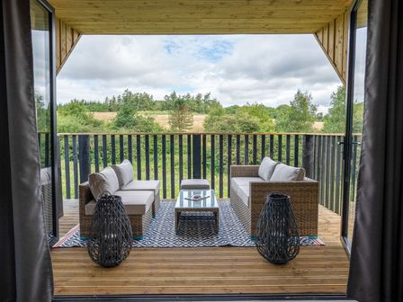 An outdoor seating area with couches and a coffee table at Orka 1.0 (Pet) Dumfries