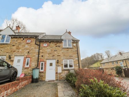 A house with a car parked in front at Ramblers Cottage in Alnwick