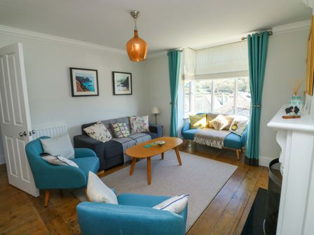 A living room with two armchairs and a coffee table at 43 Sandquay Road in Dartmouth
