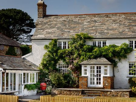 A house with plants and a garden at Whalesborough Farmhouse Spa in Marhamchurch